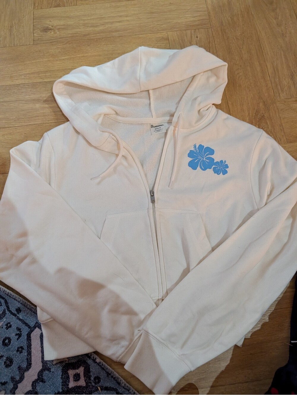 No Boundaries Women's White Zip-Up Hoodie with Blue Floral Design XS